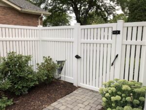 6-foot semi-privacy vinyl fence with airflow slats and a garden walk-through gate